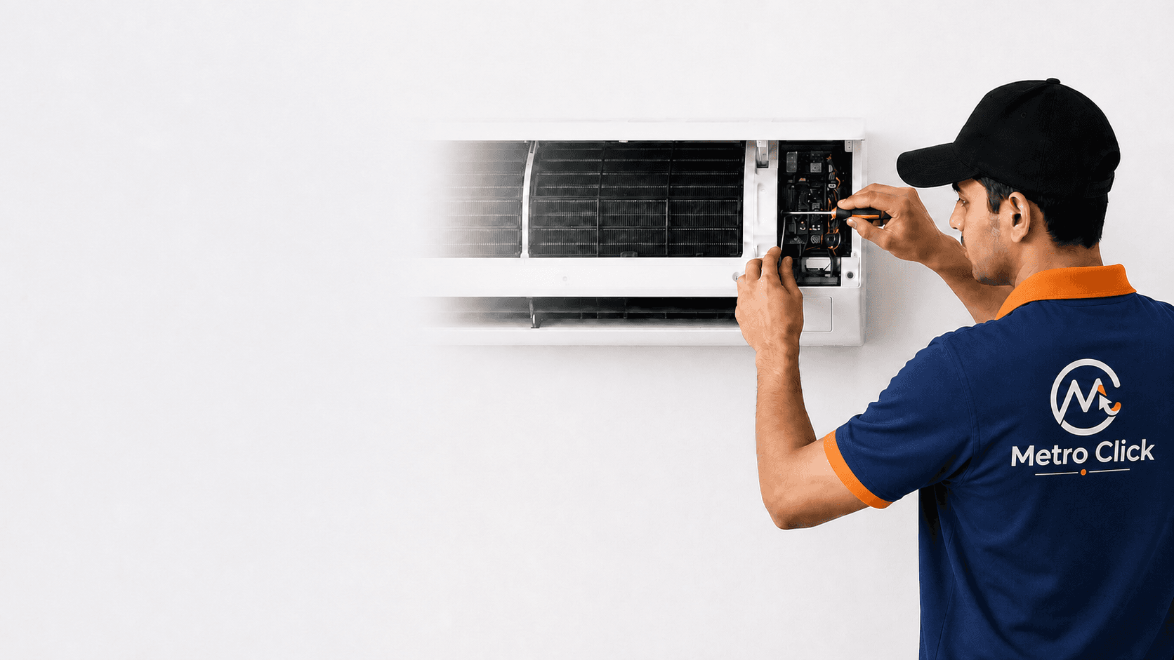 MetroClick technician servicing a wall-mounted air conditioner